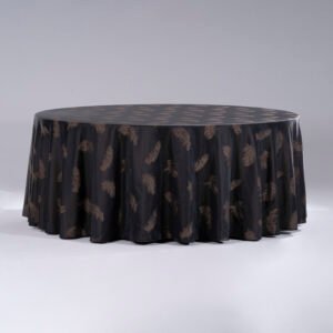 An elegant black round hotel tablecloth featuring luxury bronze feather patterns draped over a banquet table
