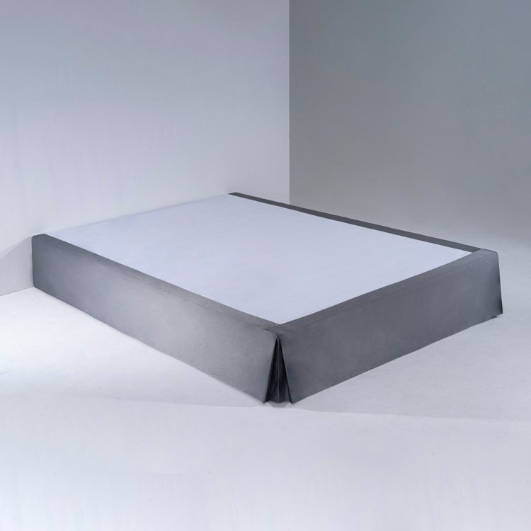 A crisp white hotel mattress fitted with a tight, smooth waterproof fitted sheet under professional lighting