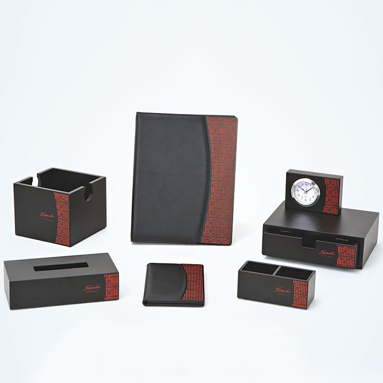 Galaxy Hospitality luxury hotel room accessory set in matte black faux leather with intricate red geometric patterned accents