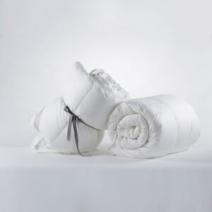 Two rolled premium white hotel synthetic duvet inserts tied with a grey ribbon showcasing high loft and soft microfiber fabric