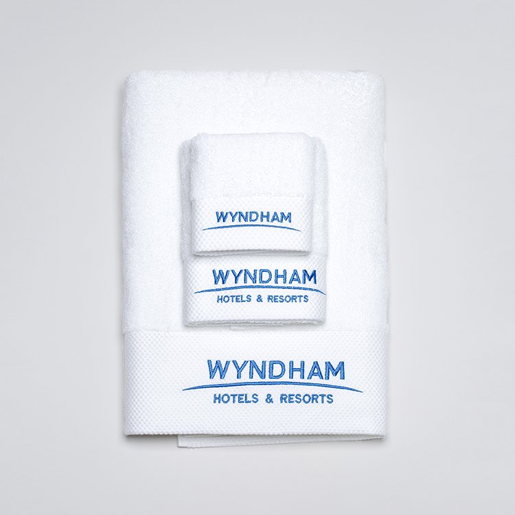 Galaxy Hospitality white luxury hotel towels with premium platinum silver satin wide borders and custom embroidered brand logo