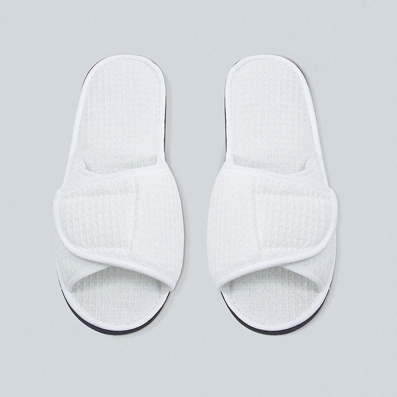 Galaxy Hospitality luxury white open-toe waffle weave disposable hotel slippers with an adjustable velcro flap