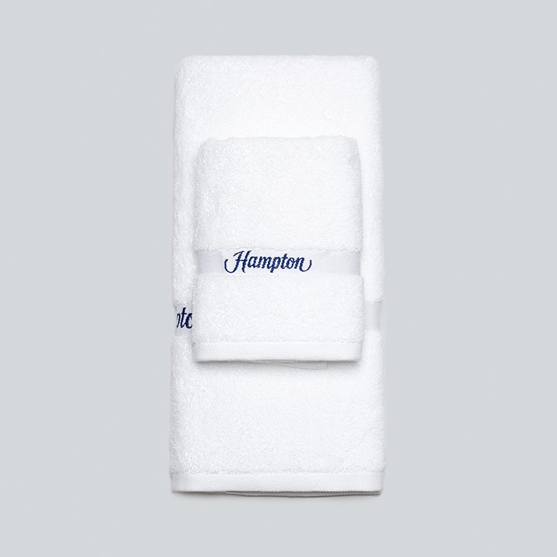 Galaxy Hospitality white luxury hotel bath towels featuring a classic textured dobby woven border near the hem