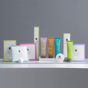 rêve thermal boutique hotel toiletries with colorful border boxes and translucent colored squeeze tubes on a glass shelf