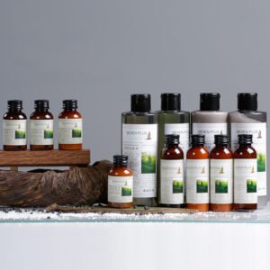 SEVEN PLUS London luxury hotel toiletries featuring nourishing green tea formulations, classic amber squeeze bottles, and large dispenser options