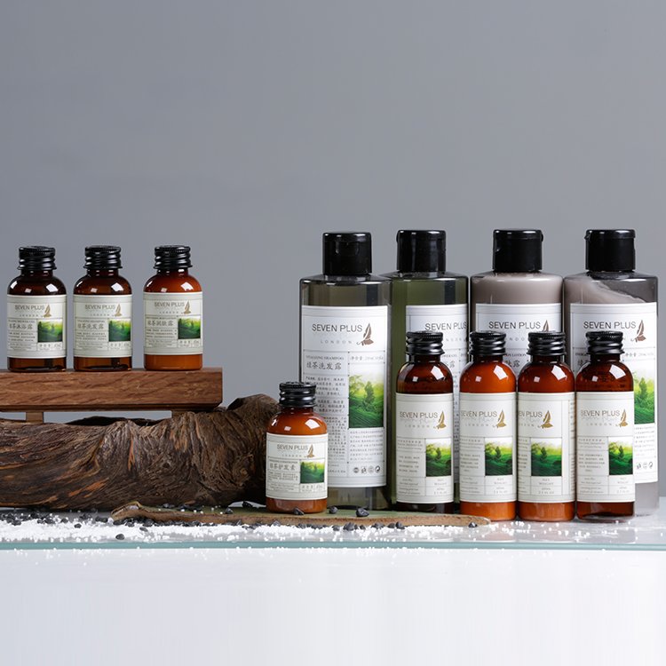 SEVEN PLUS London luxury hotel toiletries featuring nourishing green tea formulations, classic amber squeeze bottles, and large dispenser options