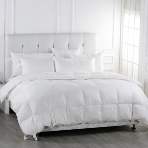 Premium white goose down hotel duvet comforter and matching fluffy pillow inserts on a luxury king-sized bed
