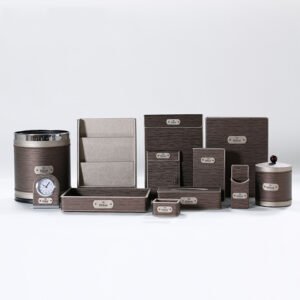 Galaxy Hospitality customizable guest room organizer set in textured brown faux leather with metallic logo plaques as styled for Hilton hotels