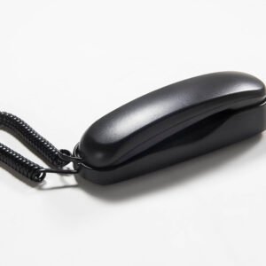 Sleek compact black hotel wall-mounted telephone featuring a slim moisture-resistant handset design