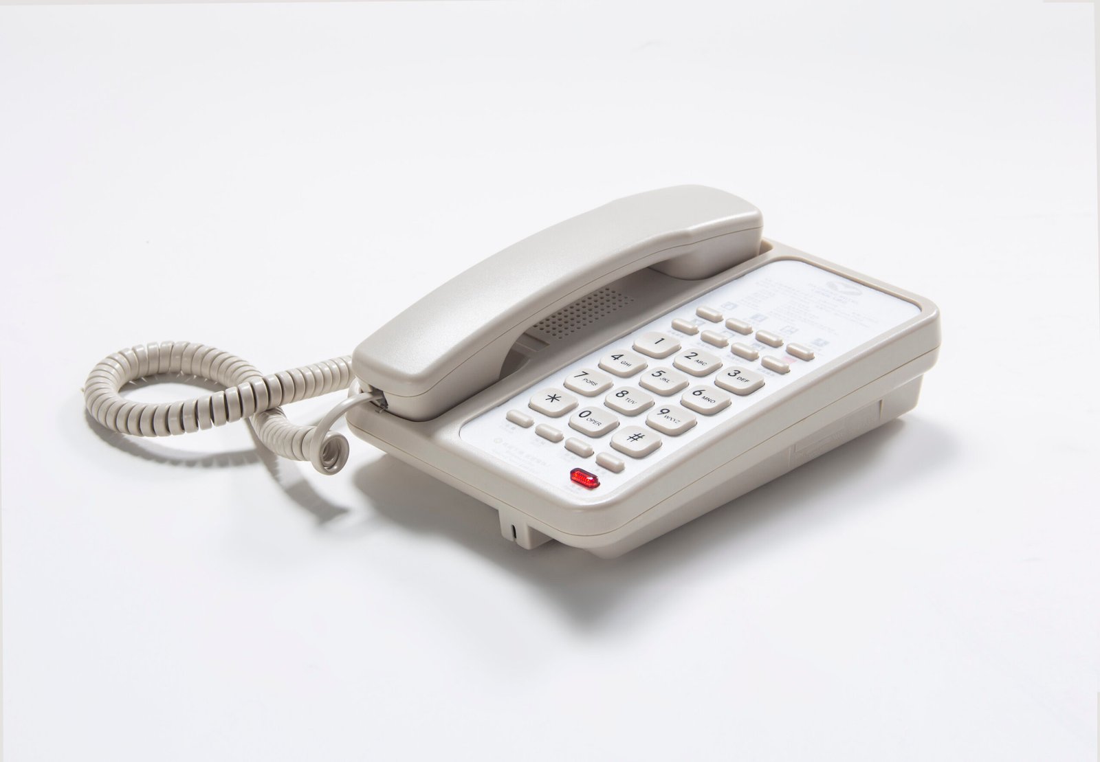 Classic beige hotel guestroom landline telephone with customizable speed dial panel and message waiting light