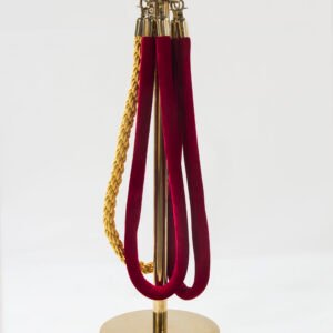 Premium polished gold hotel queue barrier stanchion featuring a spherical crown top and red velvet hanging ropes
