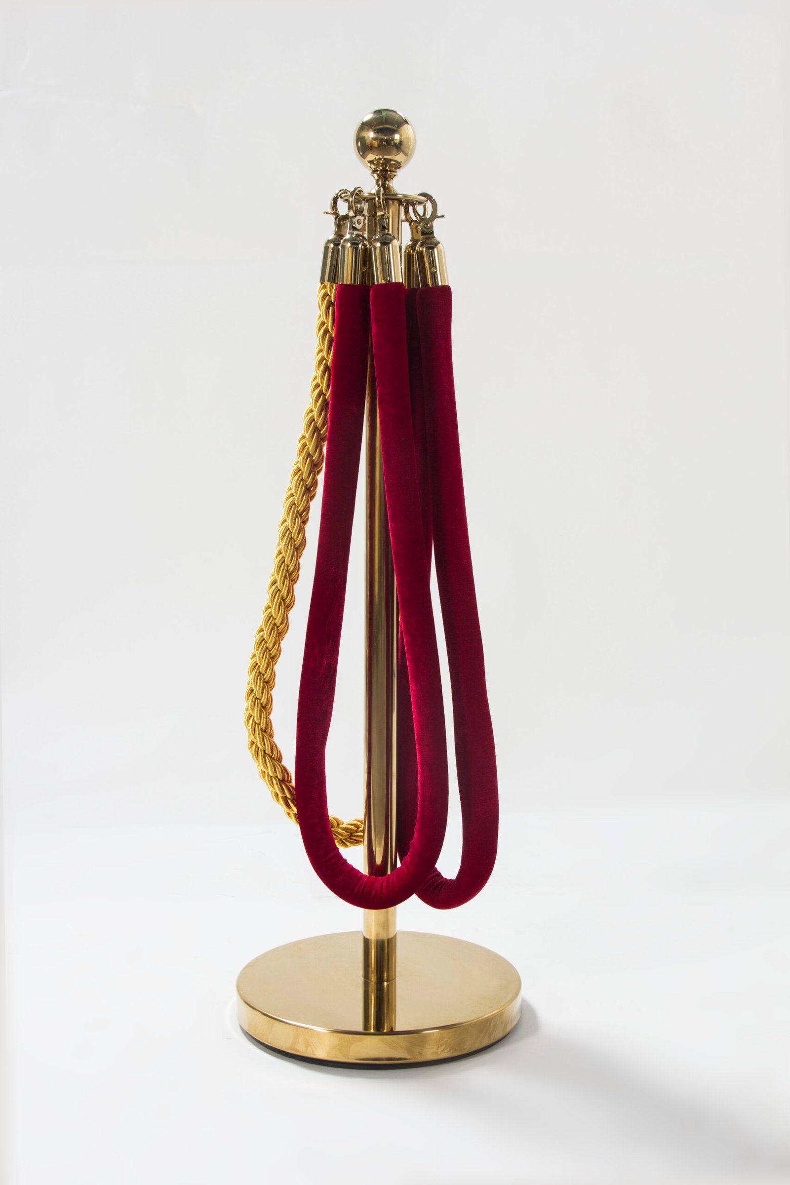 Premium polished gold hotel queue barrier stanchion featuring a spherical crown top and red velvet hanging ropes