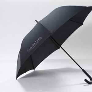 Custom printed black hotel concierge umbrella featuring a comfortable curved handle and white resort logo