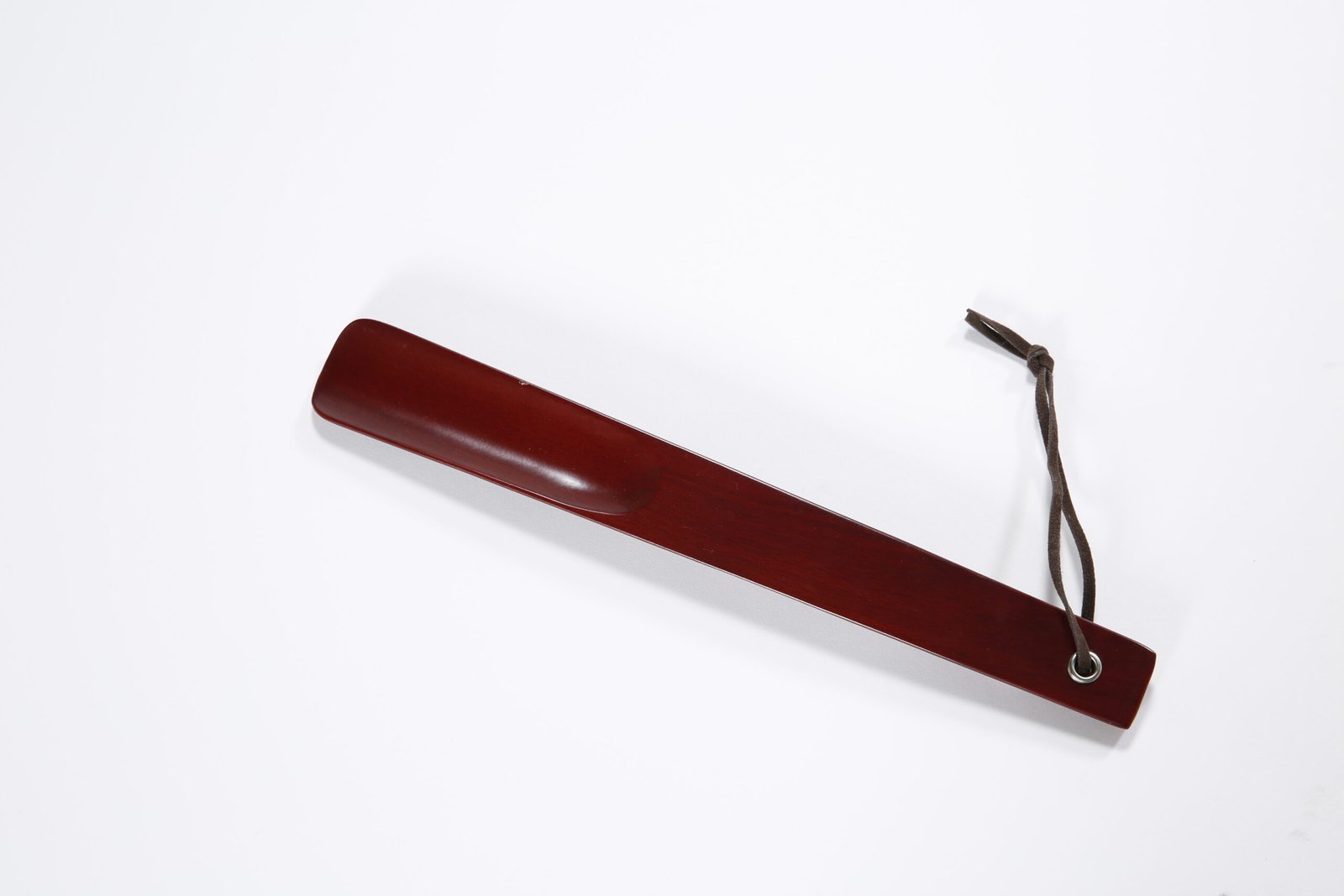 Premium dark brown wooden hotel room shoe horn with a durable leather hanging loop
