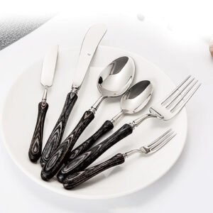 Rustic luxury wood handle cutlery set wholesale items displaying dark wooden grain handles on a white ceramic plate