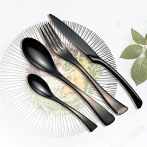 Modern luxury matte black flatware set commercial cutlery with knife, fork, and spoons on a decorated porcelain plate