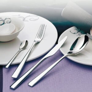 Luxury restaurant bone china cutlery set presenting fine porcelain bowls and mirror finished silver flatware on purple mats