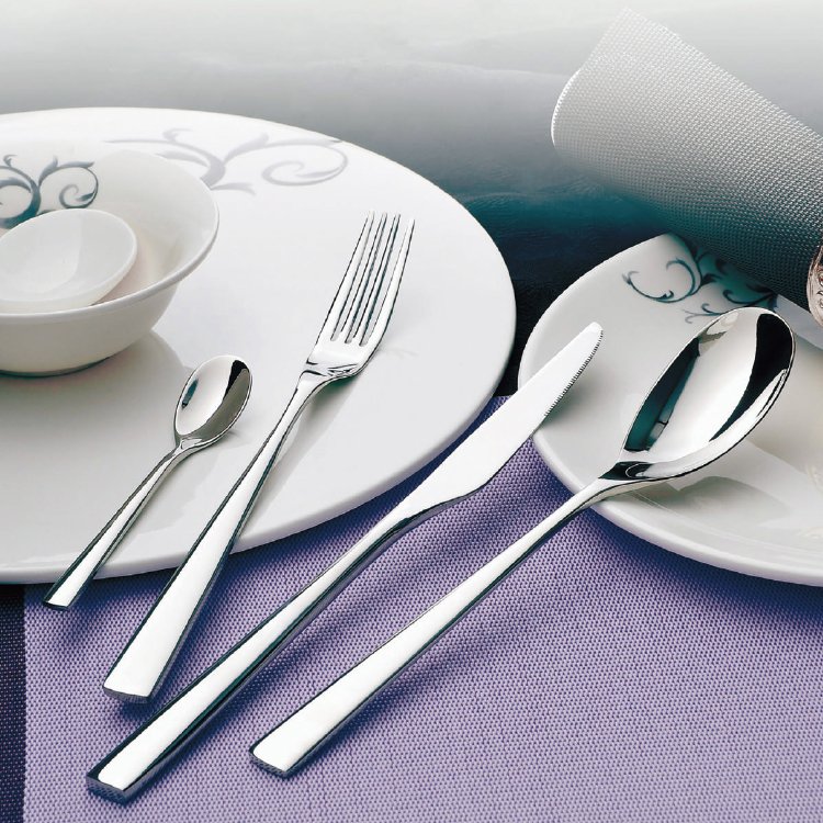 Luxury restaurant bone china cutlery set presenting fine porcelain bowls and mirror finished silver flatware on purple mats