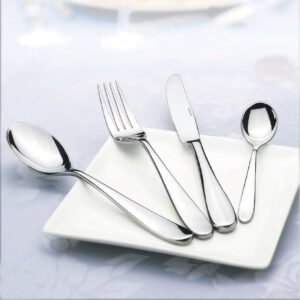 Luxury mirror polished stainless steel cutlery set restaurant flatware with dinner knife, fork, and spoons on a porcelain plate