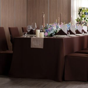 Luxury dark brown banquet table cloth wedding setup with a custom embroidered beige table runner and matching chair covers