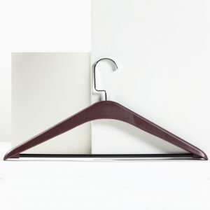 Premium dark coffee brown hotel wooden clothes hangers with anti-slip shoulder notches and a pant bar displayed for hotel closet setups