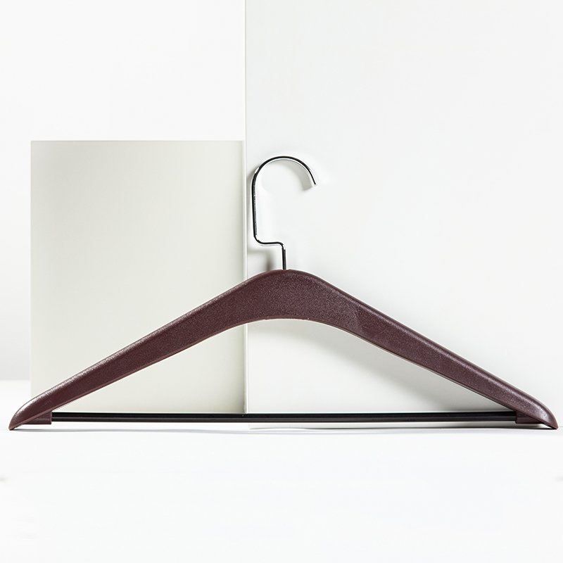 Premium dark coffee brown hotel wooden clothes hangers with anti-slip shoulder notches and a pant bar displayed for hotel closet setups