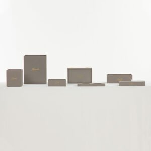 Galaxy Hospitality customizable executive guest room organizer set in textured dark grey leather showing gold hot-foil stamped Kempinski logos