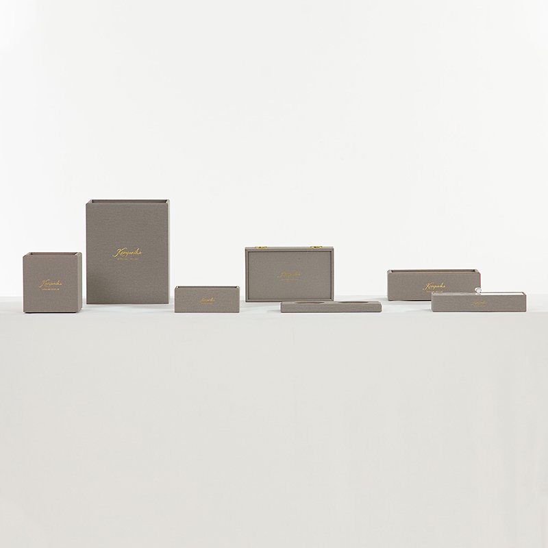 Galaxy Hospitality customizable executive guest room organizer set in textured dark grey leather showing gold hot-foil stamped Kempinski logos