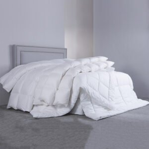 Luxury high-loft white hotel down comforter draped elegantly over a queen bed featuring durable premium baffle-box stitching