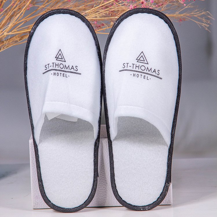 Galaxy Hospitality luxury white closed-toe disposable hotel slippers with black custom logo printing for St-Thomas Hotel
