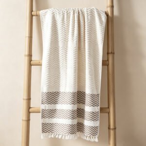 Hanging beige chevron wave jacquard beach towel with hand-tied fringe tassels and geometric contrast stripes