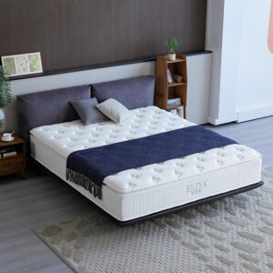 Point-tufted hotel pillow top mattress styled with navy blue runner on a modern dark bed frame