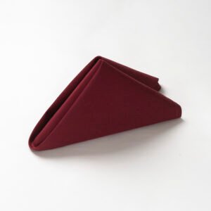 Folded deep wine red triangle wholesale burgundy cotton dinner napkins showing dense heavyweight plain weave texture