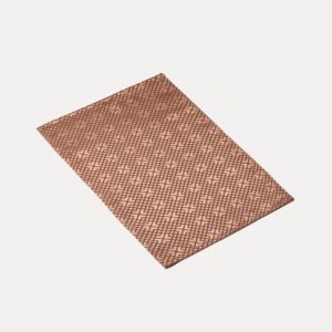 Rectangular wholesale polyester geometric jacquard placemats showing rose gold, ocean blue, and pearl white interlocking grid textures
