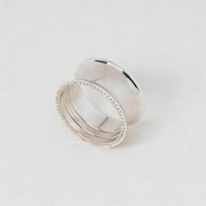 Polished silver napkin ring featuring a smooth mirror finish and an elegant beaded rim border on a white background