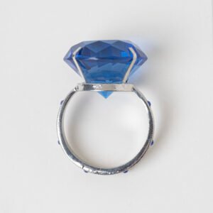 Vintage silver napkin ring shaped like a giant blue gemstone ring with filigree band and blue accent crystals