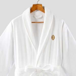 White cut pile velour luxury hotel bathrobe with shawl collar and custom gold embroidery