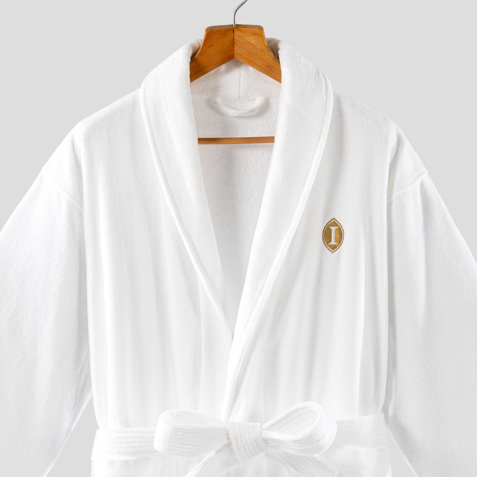 White cut pile velour luxury hotel bathrobe with shawl collar and custom gold embroidery