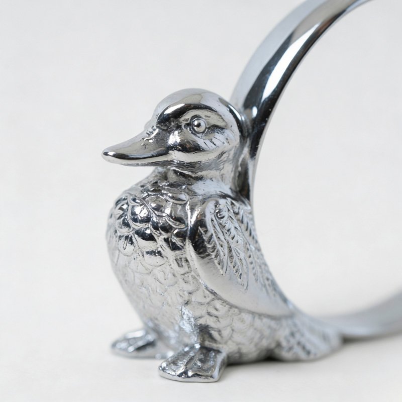 Polished silver duck napkin ring featuring a 3D sculpted duckling with detailed feather textures