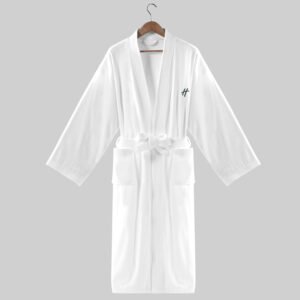 Plush white velour hotel bathrobe with shawl collar and custom logo embroidery