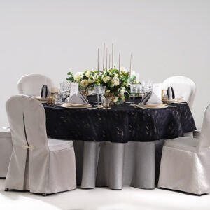 Navy blue textured tablecloth set styled with silver grey overlays and fitted chair covers for luxury hotel ballrooms